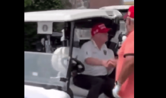Trump seated golf cart